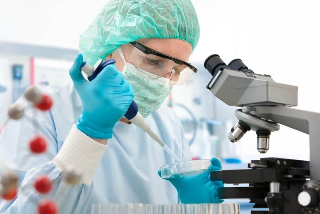 Scientist with dropper working  at the laboratory