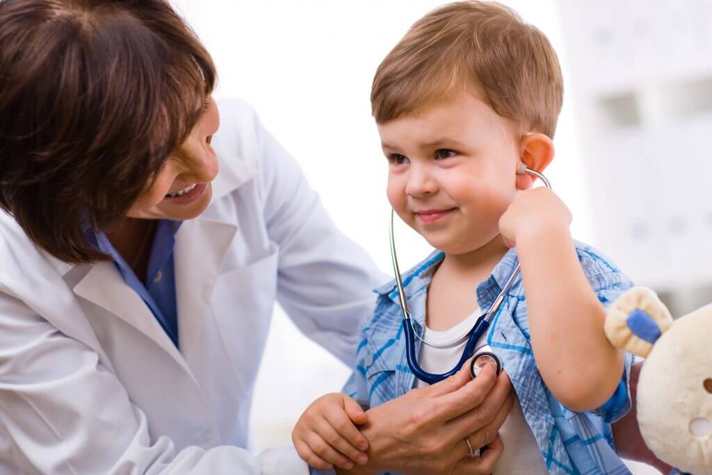 Doctor examining child