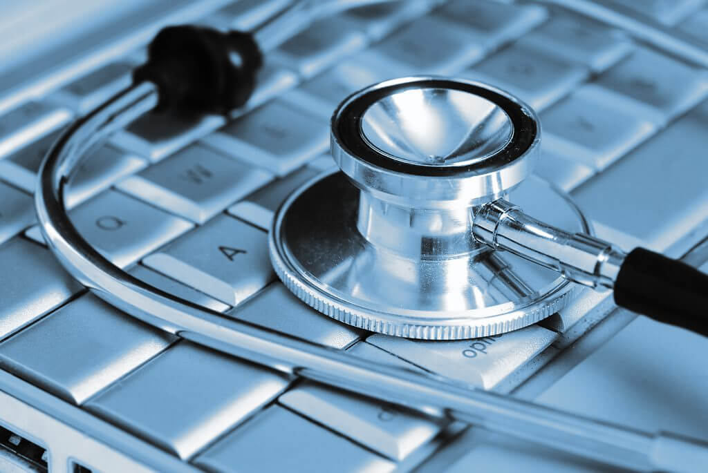 Technology and medicine - Silver stethoscope over laptop keyboar